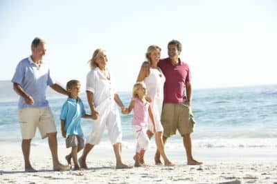 A family walking along the beach