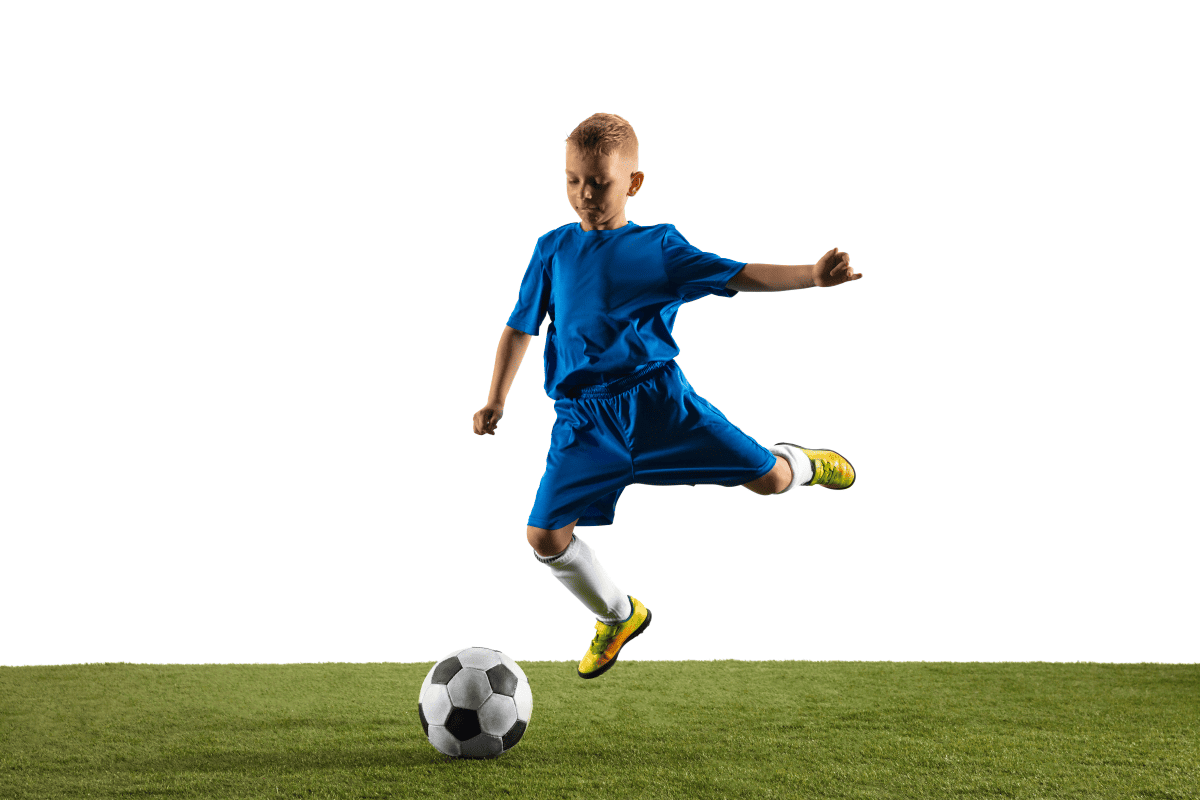 A young boy playing soccer